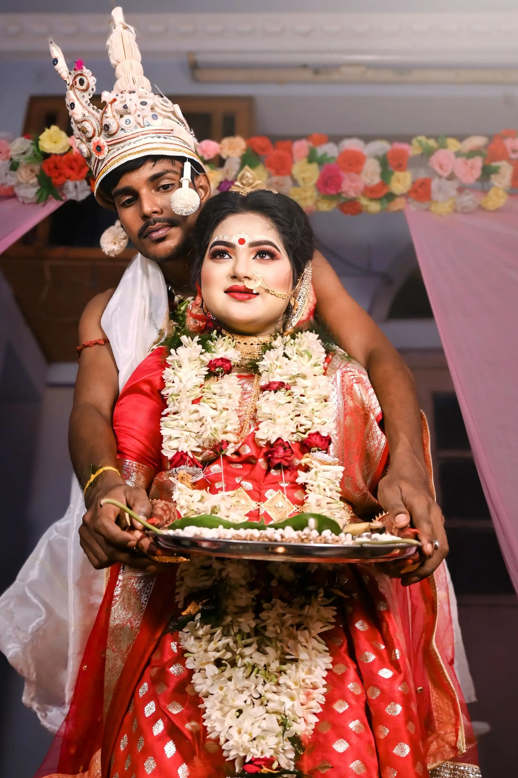 Bengali bride carries a ceremonial tray during a wedding ritual