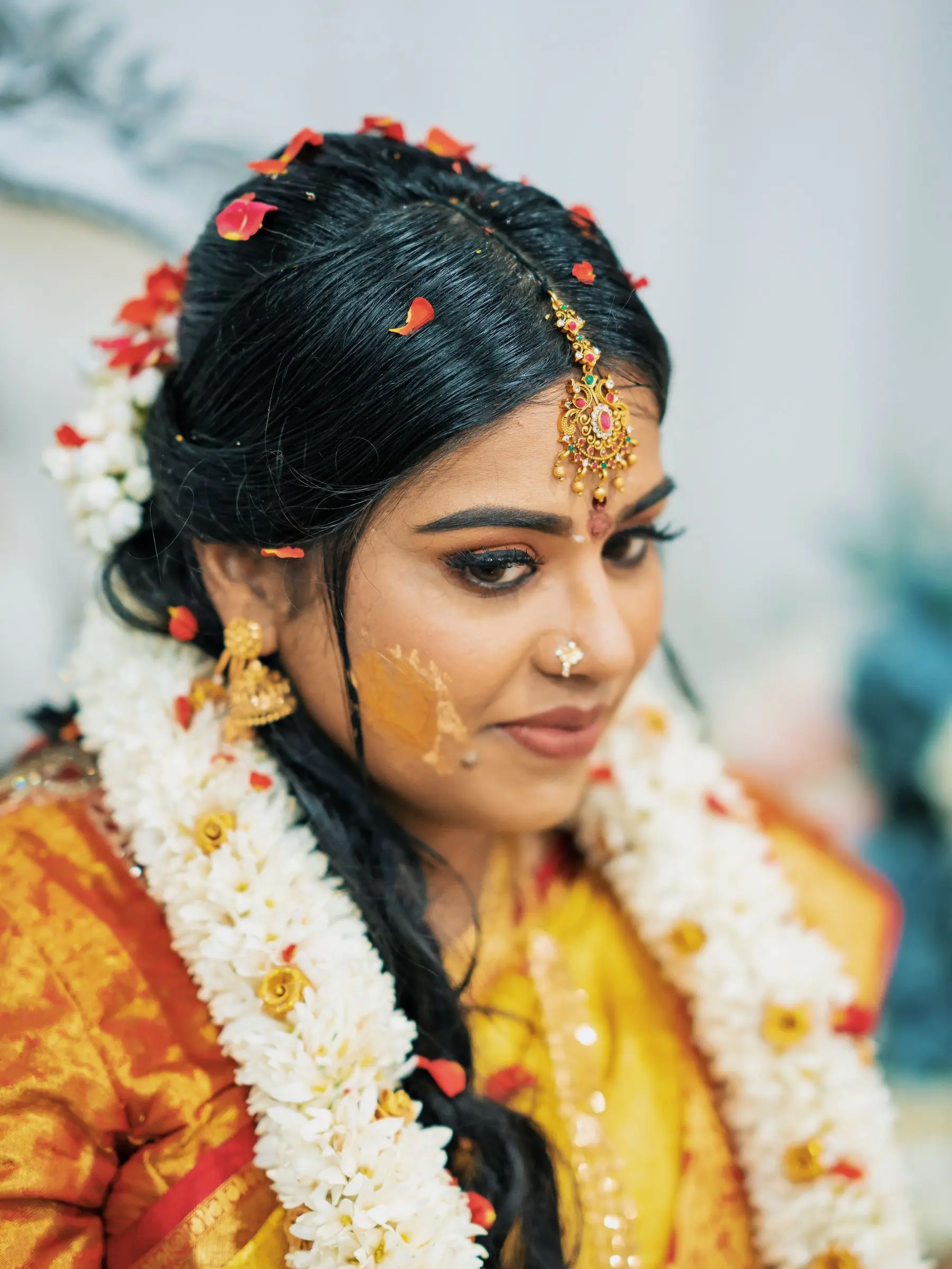 A bride in traditional attire during a haldi celebration.
